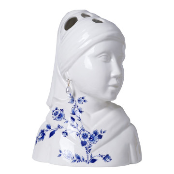Een vaas in de vorm van het meisje met de Parel.  Bloemen kunnen in de openingen bovenop het hoofd worden gestoken.  Haar omslagdoek is gedecoreerd met Delfts blauwe bloemen.